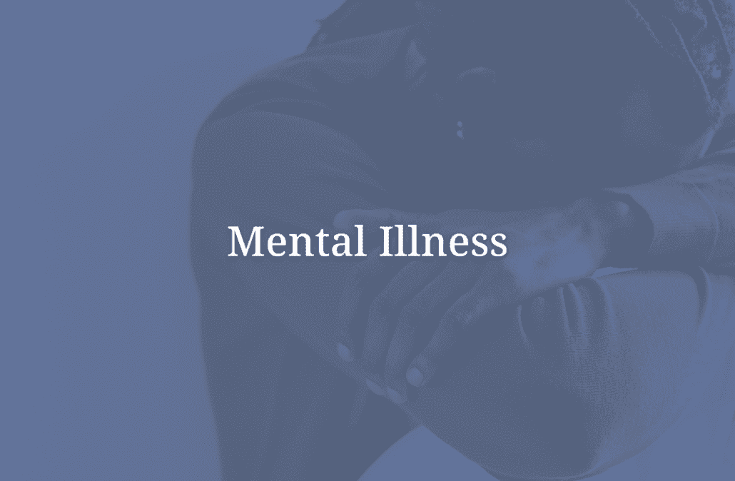 A man sitting against the wall with his head down. "Mental Illness" overlays the image.