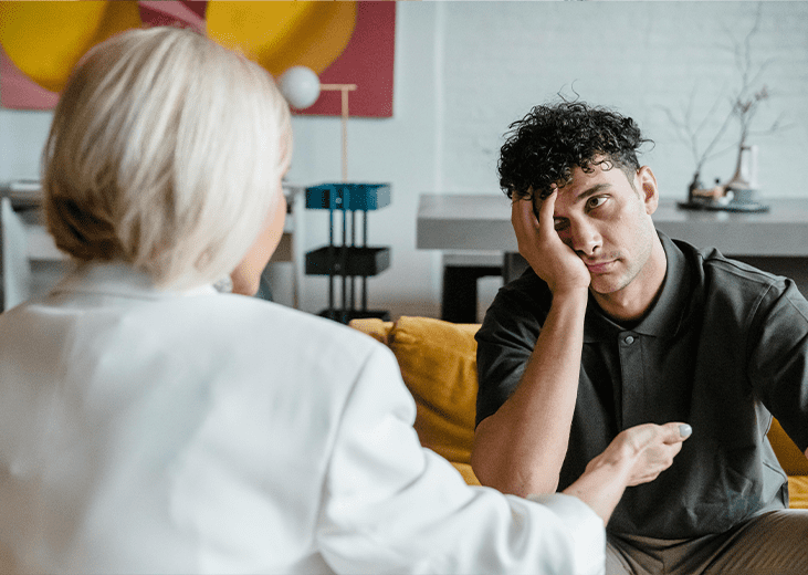 A frustrated man speaking with a therapist. Integrea Community Mental Health System offers many services for those with substance use disorders.