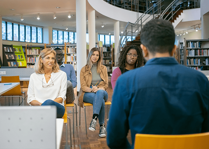 A group of adults meeting in a library to learn about community mental health prevention services. Integrea Community Mental Health System offers many prevention services to those with mental health illnesses or substance use disorders.