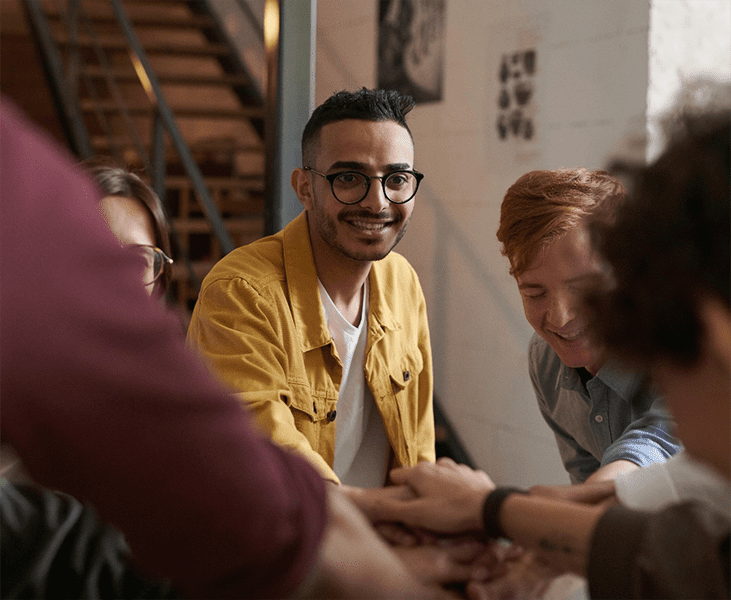 A young man smiling with friends. Integrea Community Mental Health System offers many services for those mental health illnesses and substance use disorders.