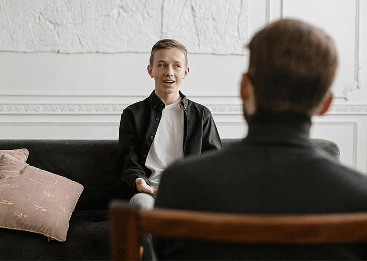 A young adult speaking with a therapist. Integrea Community Mental Health System offers many services for families and children.