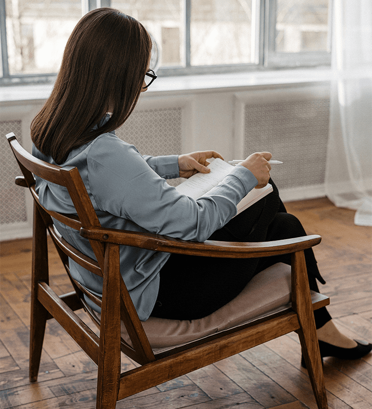 A therapist reading over her notes. Integrea Community Mental Health System offers many services for those with substance use disorders.