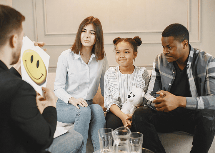 Family consisting of mother, father, and young daughter meeting with a mental health service provider. Integrea Community Mental Health System offers many services for those with family and children.